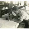 Man using electric cloth cutter
