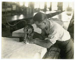 Man using electric cloth cutter