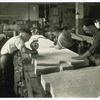Men using electric cloth cutter