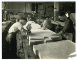 Men using electric cloth cutter