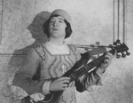 Alfred Lunt as Marco Polo, with a guitar.
