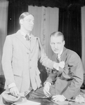 Alfred Lunt as Raphael Lord and Douglass Montgomery as Douglas Carr (seated).