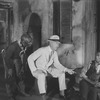 Scene in Catfish Row. Frank Wilson as Porgy (on knees by steps), Wesey Hill as Jack (extreme left).