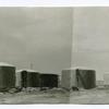 View of storage tanks and agitator and bleachers, Sunburst Refinery.