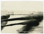 Two oil pipelines spewing oil into an oil lake