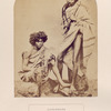 Kurumbars,  Nieelgerries. (men, one standing and one sitting)