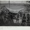 Bier bearers rest after crossing rice fields