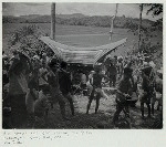 Bier bearers rest after crossing rice fields