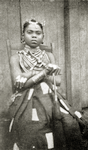 Kru woman with " shield " finger rings and hair ornaments.