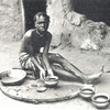 A woman making clay pots, Liberian Western Homeland.