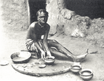 A woman making clay pots, Liberian Western Homeland.
