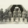 Seven officers standing before the tent housing the office of the Chief Staff