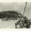 US Army Transport leaving Santiago, Cuba, enroute to  the United States. Wreck of Spanish Cruiser on left. 1898.