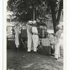 Army Rolling Kitchen in use. Lifting boilers of cooked food out of cooker & placing them in thermos. 6-1918.