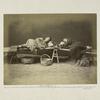 Opium Smoking, The Man on the Left is Under the Influence of His Fourth or Fifth Pipe, The Other is Cooking a Pipeful of Opium Preparatory to Smoking it