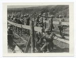 In the captured salient of St. Mihiel. American engineers making rolling barbed wire entanglements. The boards serve as racks to hold the hoops in place while the wires are being strung.