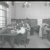 Aguilar [Librarian with children gathered around table]