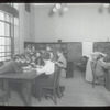 Aguilar [Librarian with children gathered around table]