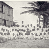 Nevis; "We seat them to be photographed with the school mistress in the back."