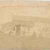 [Unidentified : staff at USSC station?] : [Woman and man with stove top hat stand on porch of wooden house, a man stands near porch while another person works in foreground, two women depart, one carries a basket.]
