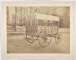 Howard ambulance, rear and side view, tailgate up, on city street.