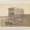 Howard ambulance, front and side view, interior view of opened wooden box (for limb support) on ground. Background masked.