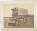Howard ambulance, front and side view, interior view of opened wooden box (for limb support) on ground. Background masked.