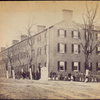 View on Pennsylvania Avenue, Washington, D.C. [Soldiers, civilians and children stand in front of a large brick corner building.]