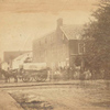 Headquarters U.S. Sanitary Commission Gettysburgh [sic]. [Wagon from “Supply Train 2nd Divn 6th Corps” in front of U.S. Sanitary Commission building, group standing in front of building]
