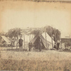 [Four men in front of sheltered tent next to U.S. Christian Commission wagon, another tent at rear left.] / Alexander Gardner