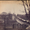 Main St. : Petersburg [Wagon train on street, church steeple in distance]