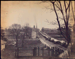 Main St. : Petersburg [Wagon train on street, church steeple in distance]