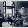 Art collection. Librarian at bookshelf with girl, others reading [58th Street Branch]