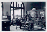Art collection. Librarian at bookshelf with girl, others reading [58th Street Branch]