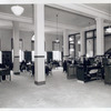 Seated readers and line at desk, Fordham Branch