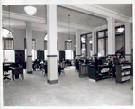 Seated readers and line at desk, Fordham Branch