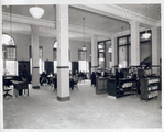 Seated readers and line at desk, Fordham Branch