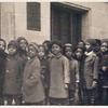 Children in line waiting to go into library]