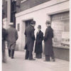 Exterior, men looking in at window display