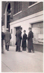 Exterior, men looking in at window display