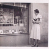 Exterior, woman looking in at window display