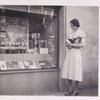 Exterior, woman looking in at window display