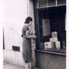 Exterior, woman looking in at window display