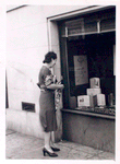 Exterior, woman looking in at window display