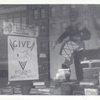 Exterior, window display asking patrons to give books to the army and navy