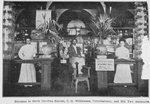 Entrance to North Carolina Exhibit, C. H. Williamson, Commissioner, and his two assistants.