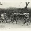 The American advance in the Argonne. German prisoners carrying German wounded to American dressing stations behind the lines in the Argonne. The two men walking in the rear are slightly wounded.