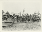 A tank moving up to the front [?]. German prisoners carry wonded to the rear. Close to battleline on the 1st morning of the assault on St. Mihiel Salient. 9-1918.