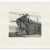 Life of an aviation cadet at Kelly Field, Texas. A cadet climbing into a plane for the first time. Note how awkwardly he bumps his foot against the seat in the plane. (5-1-1918)