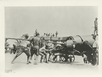 A half-tone shell being rammed into a disappearing gun.